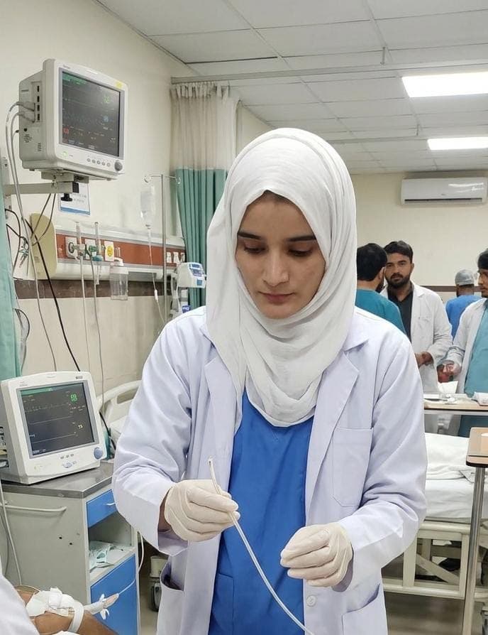 Nurse preparing a line at a patient's bedside